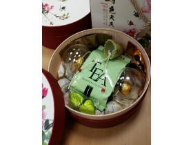 Подарок в круглой коробке с зеленым чаем